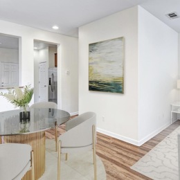 a living room with a dining table and couches